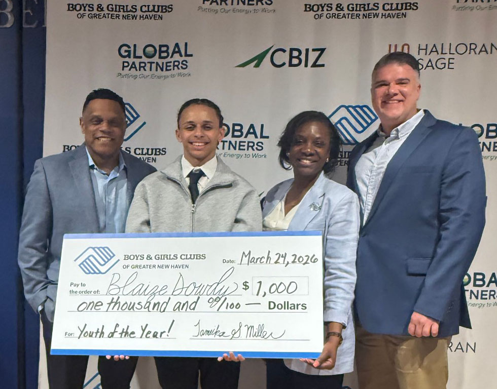 Blaize Dowdy, 2026 Youth of the Year, receiving his $1,000 scholarship check along with BGCGNH leadership